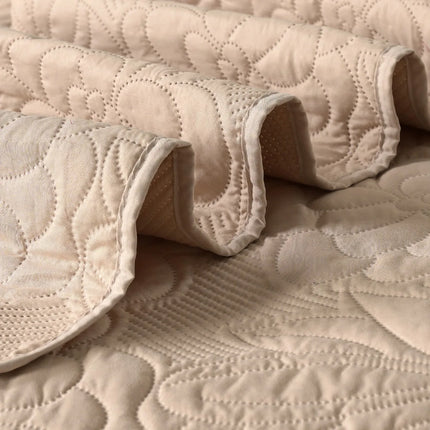 Close-up of beige quilted fabric with a textured pattern