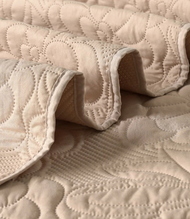 Close-up of beige quilted fabric with a textured pattern