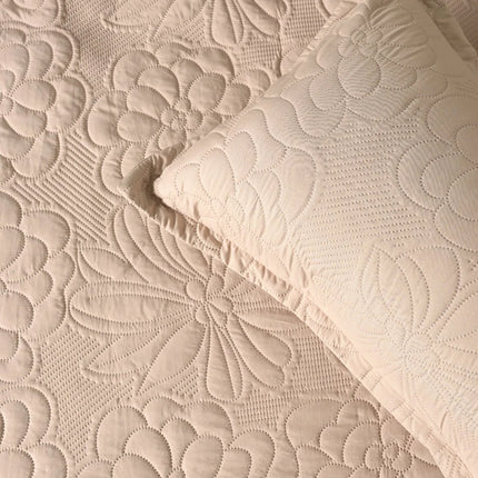 Quilted beige fabric with floral pattern and matching pillow