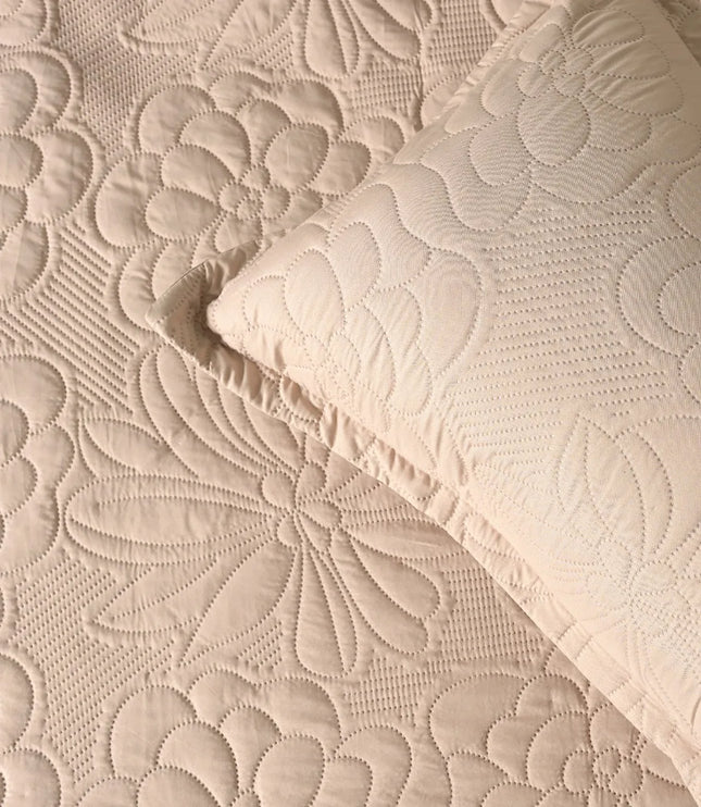 Quilted beige fabric with floral pattern and matching pillow
