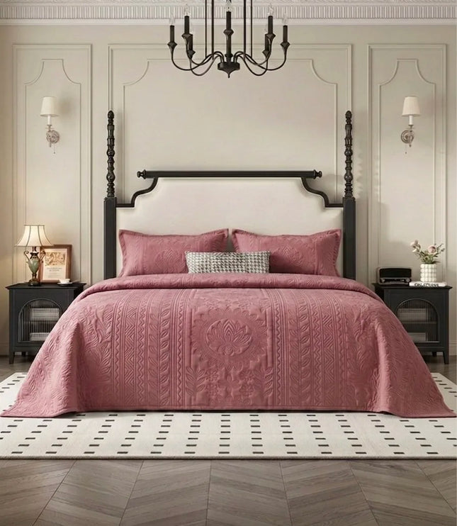 Bedroom with a four-poster bed covered in a pink quilt, nightstands, and a chandelier.