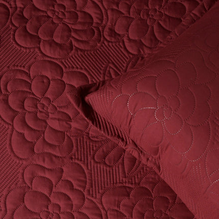 Close-up of red textured fabric with floral patterns