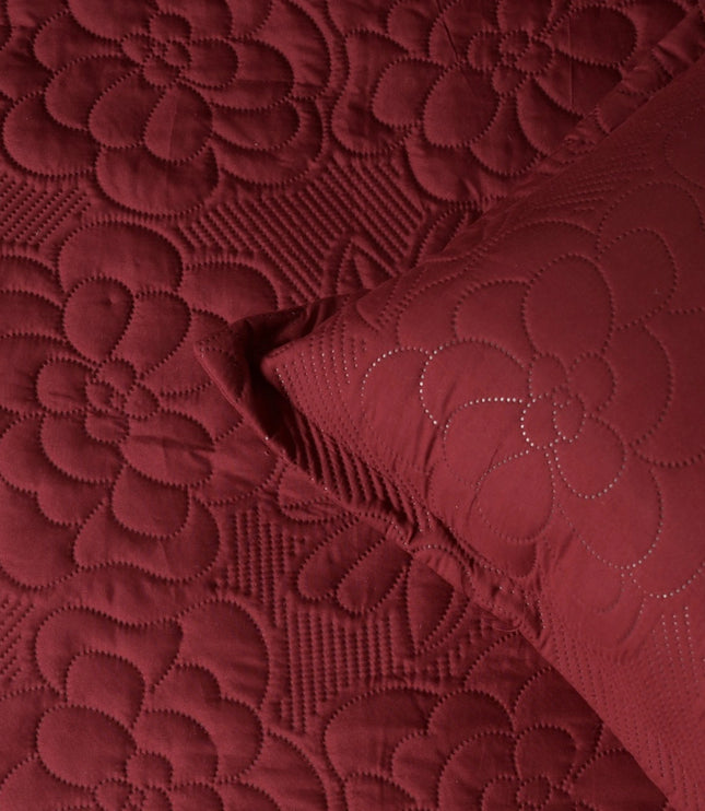 Close-up of red textured fabric with floral patterns