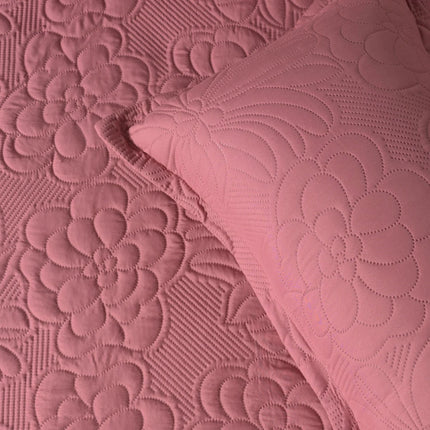 Close-up of pink textured fabric with floral patterns