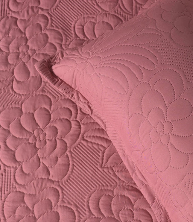 Close-up of pink textured fabric with floral patterns