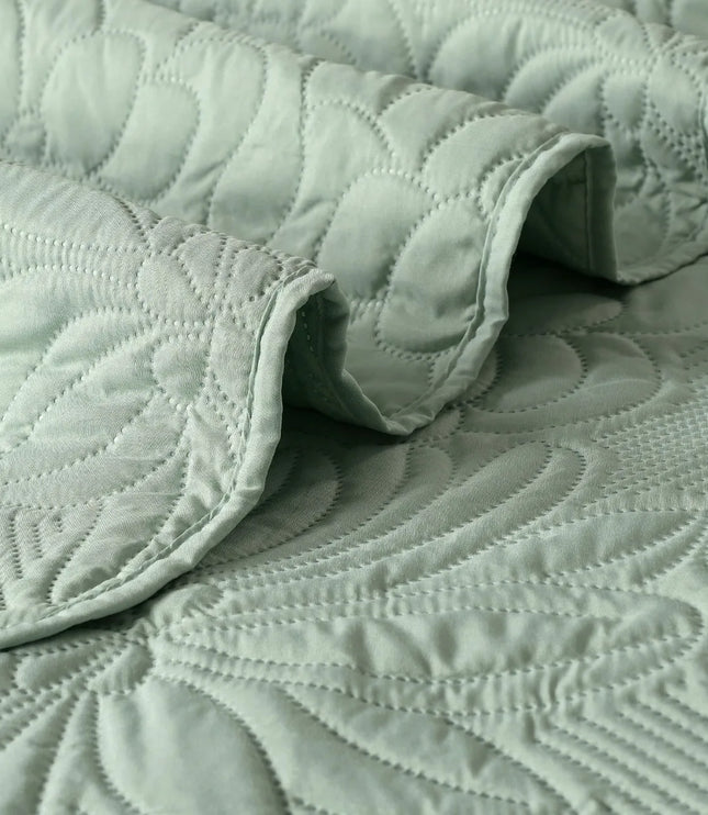Quilted green fabric with a textured pattern