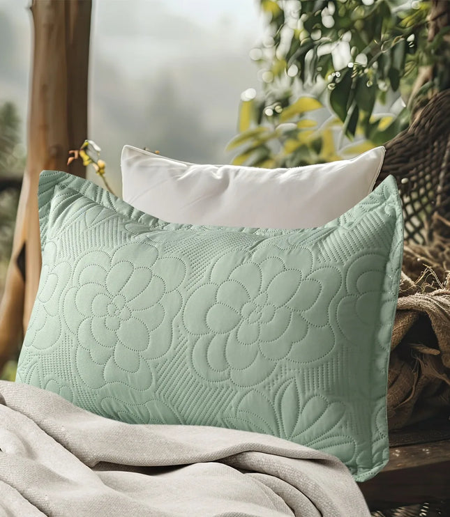 Textured green pillow on a surface with a blurred natural background