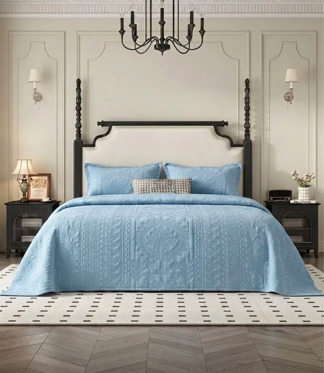Bedroom with a bed covered in a blue quilt, wooden headboard, and decorative elements.
