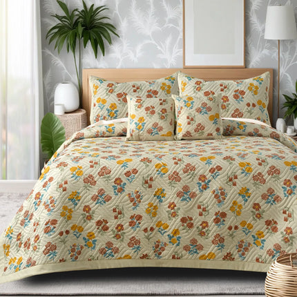 Floral patterned bedding set on a bed with decorative pillows and plants in the background.