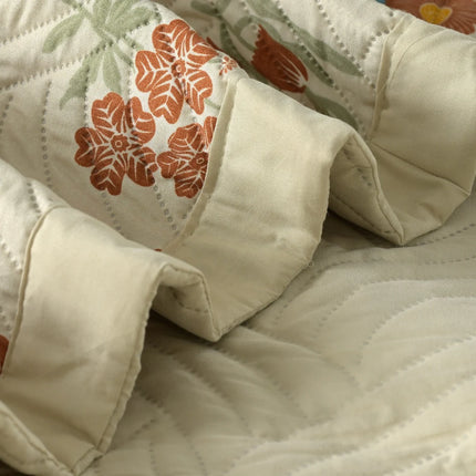 Close-up of a quilt with floral patterns on a textured surface