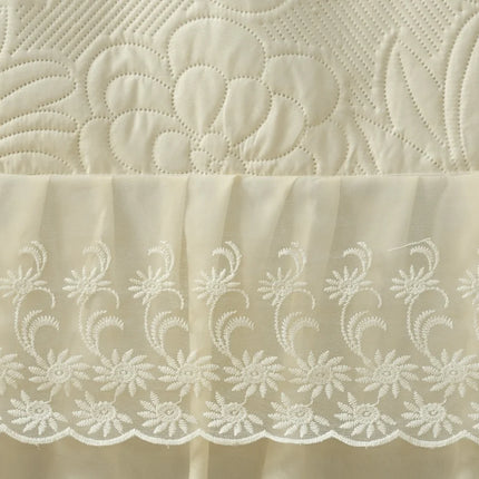 Close-up of embroidered fabric with floral patterns on a beige background