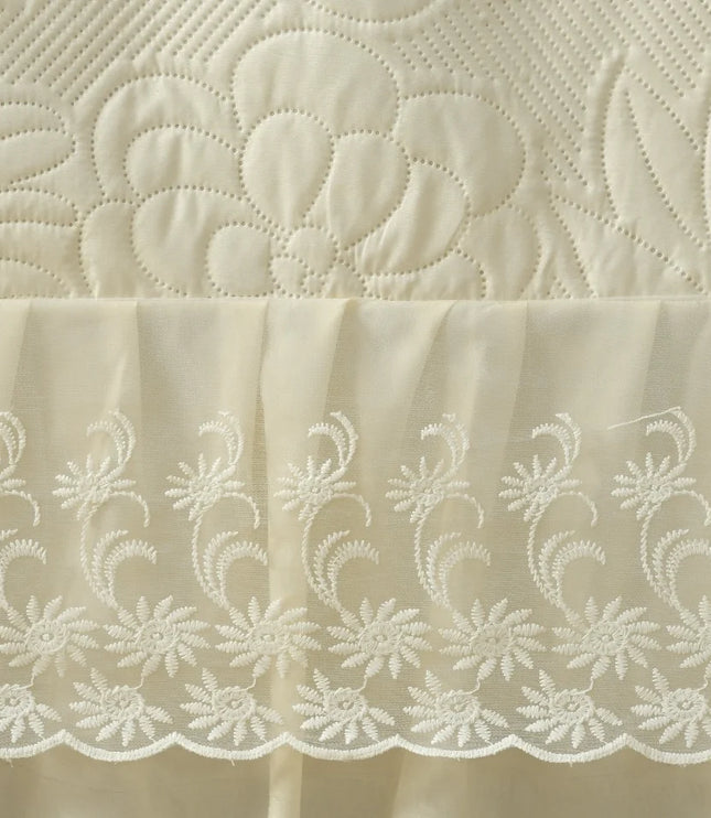 Close-up of embroidered fabric with floral patterns on a beige background