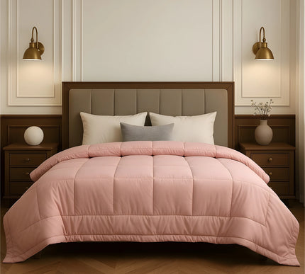 Bedroom with a neatly made bed featuring baby pink bedding and wooden furniture.