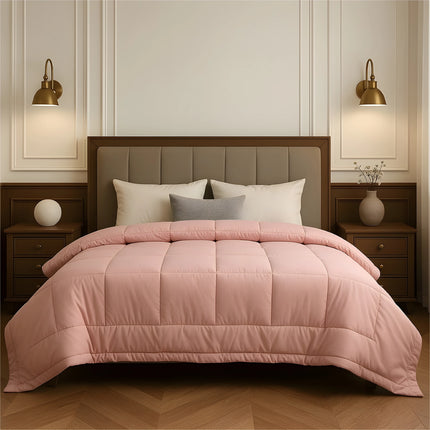 Bedroom with a neatly made bed featuring baby pink bedding and wooden furniture.