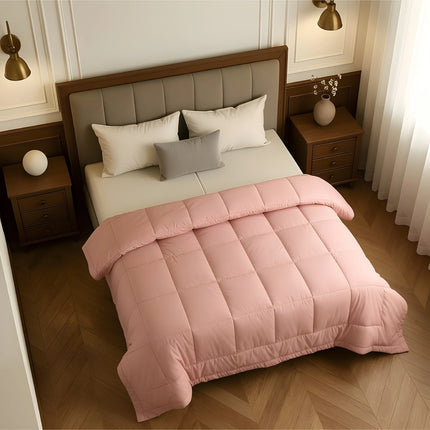 Bedroom with a neatly made bed featuring baby pink bedding and wooden furniture.