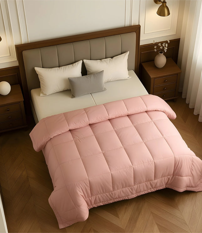 Bedroom with a neatly made bed featuring baby pink bedding and wooden furniture.