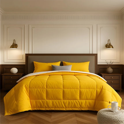Bedroom with a neatly made bed featuring yellow bedding and wooden furniture.