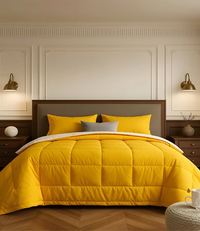 Bedroom with a neatly made bed featuring yellow bedding and wooden furniture.