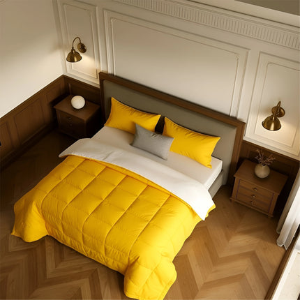 Bedroom with a neatly made bed featuring yellow bedding and wooden furniture.