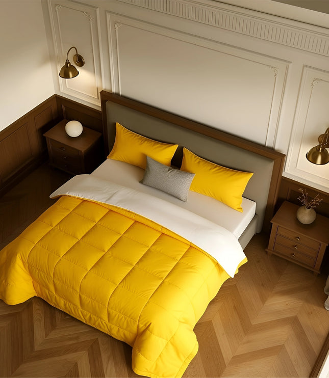 Bedroom with a neatly made bed featuring yellow bedding and wooden furniture.
