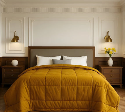 Bedroom with a neatly made bed featuring yellow bedding and wooden furniture.