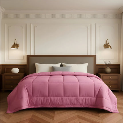 Bedroom with a neatly made bed featuring pink bedding and wooden furniture.