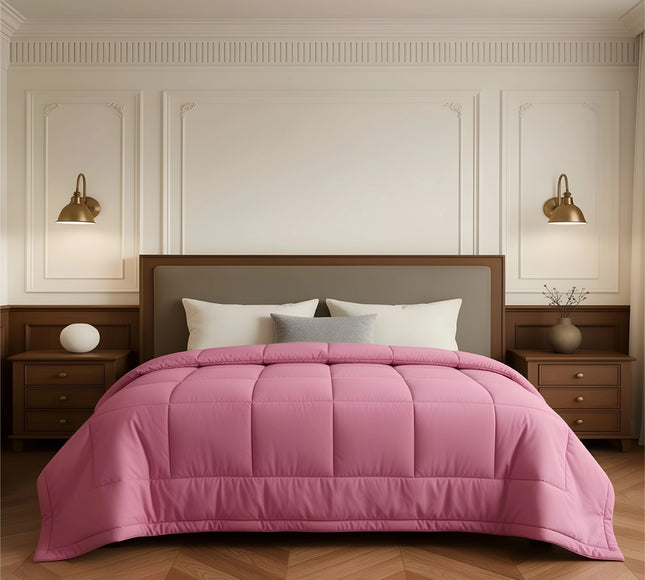 Bedroom with a neatly made bed featuring pink bedding and wooden furniture.