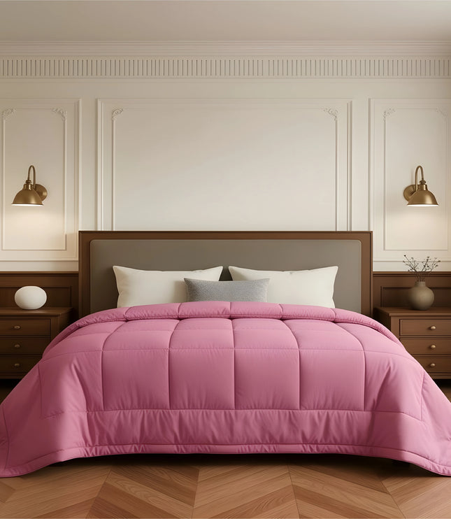 Bedroom with a neatly made bed featuring pink bedding and wooden furniture.