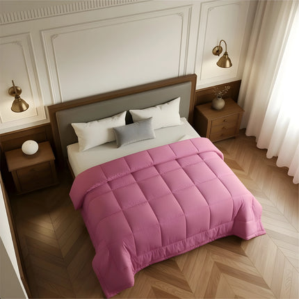 Bedroom with a bed covered in a pink comforter, wooden nightstands, and white walls.