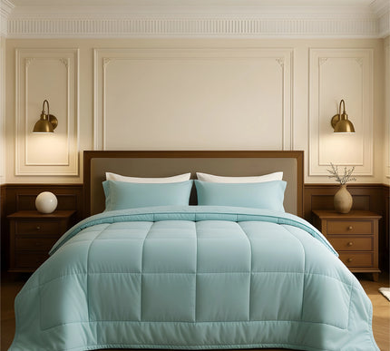 Bedroom with a neatly made bed featuring sky blue bedding and wooden furniture.