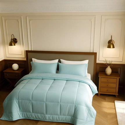 Bedroom with a bed covered in light blue comforter and pillows, wooden nightstands, and wall lamps.