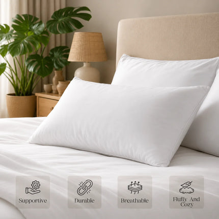 White pillows on a bed with a lamp and plant in the background, featuring icons and text about pillow qualities.